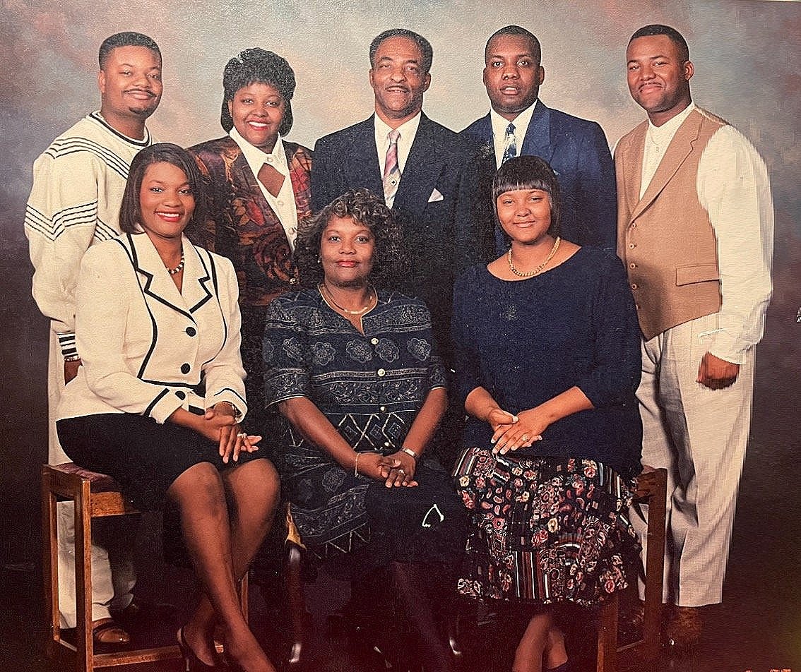 Formal family portrait of eight relatives across two generations