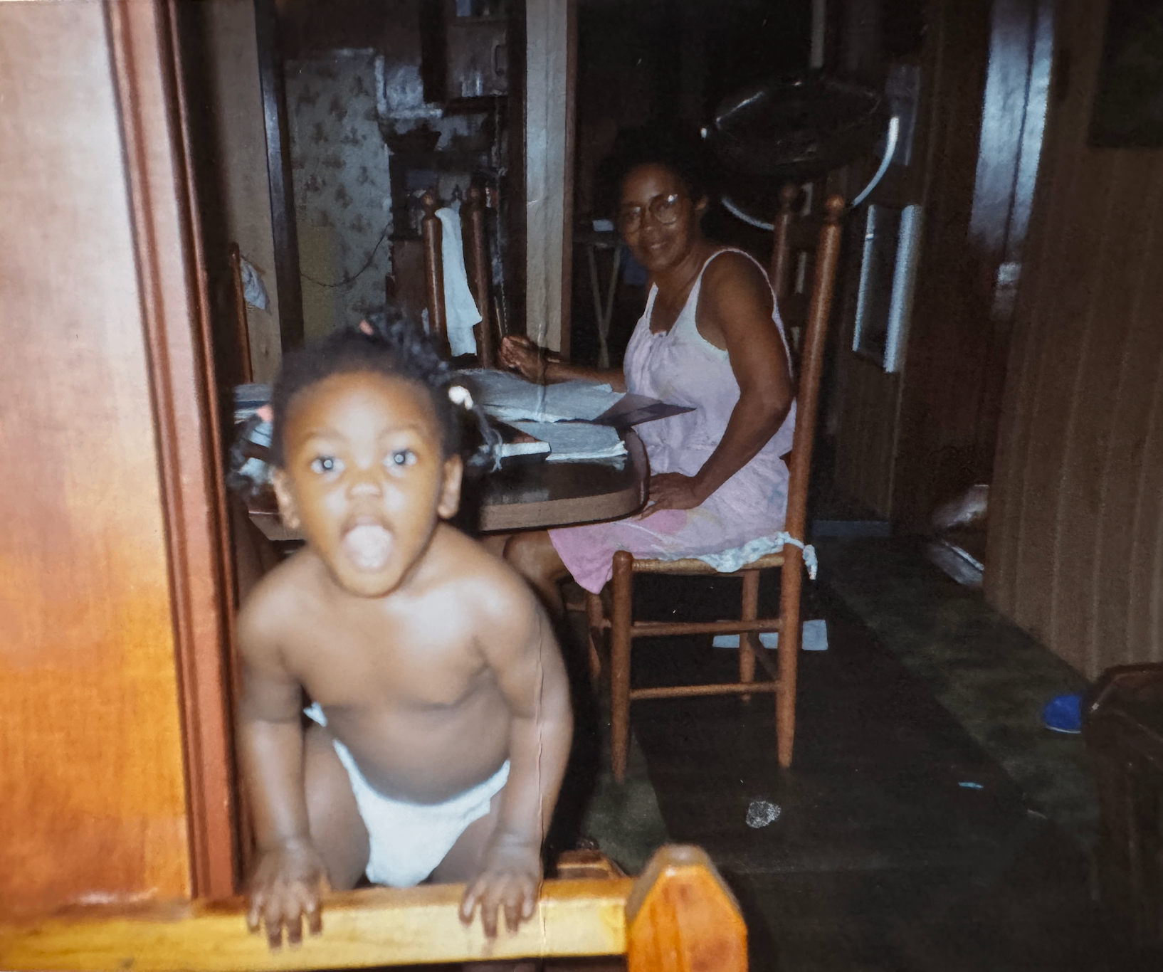 Grandmother at the table with a young grandchild at home